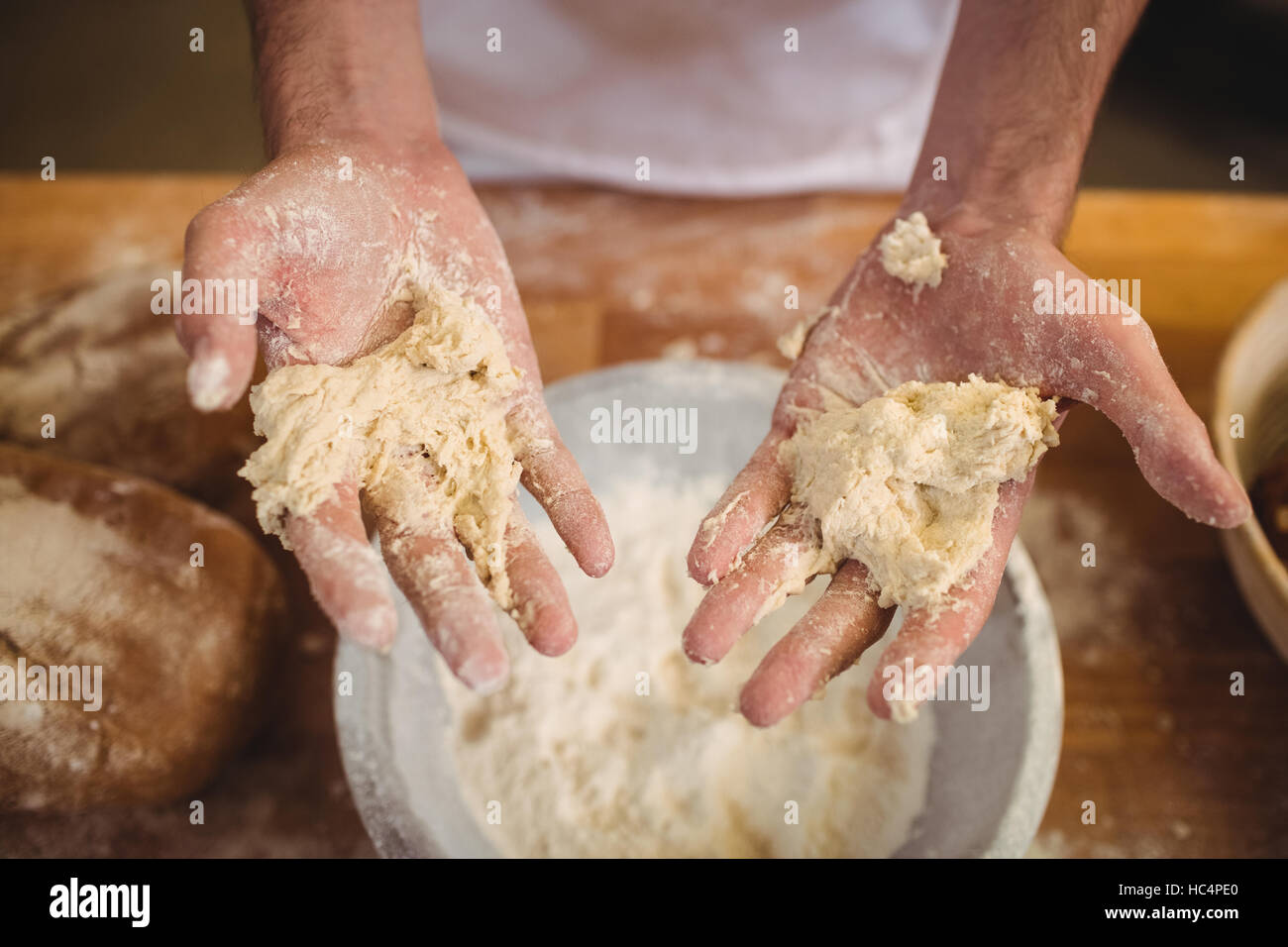 Hands of baker mixing flour by hand Stock Photo Alamy