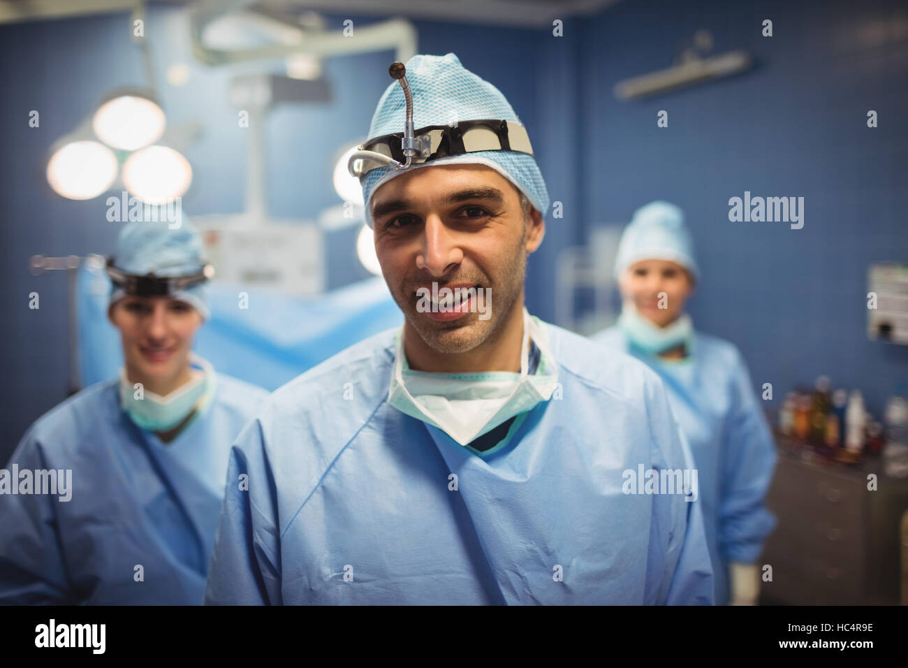 Portrait of surgeon and nurses standing in operation room Stock Photo ...