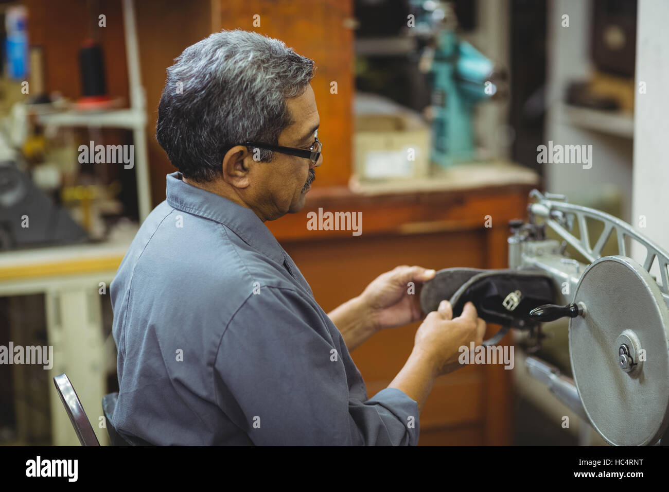 Shoemaker using sewing machine Stock Photo Alamy