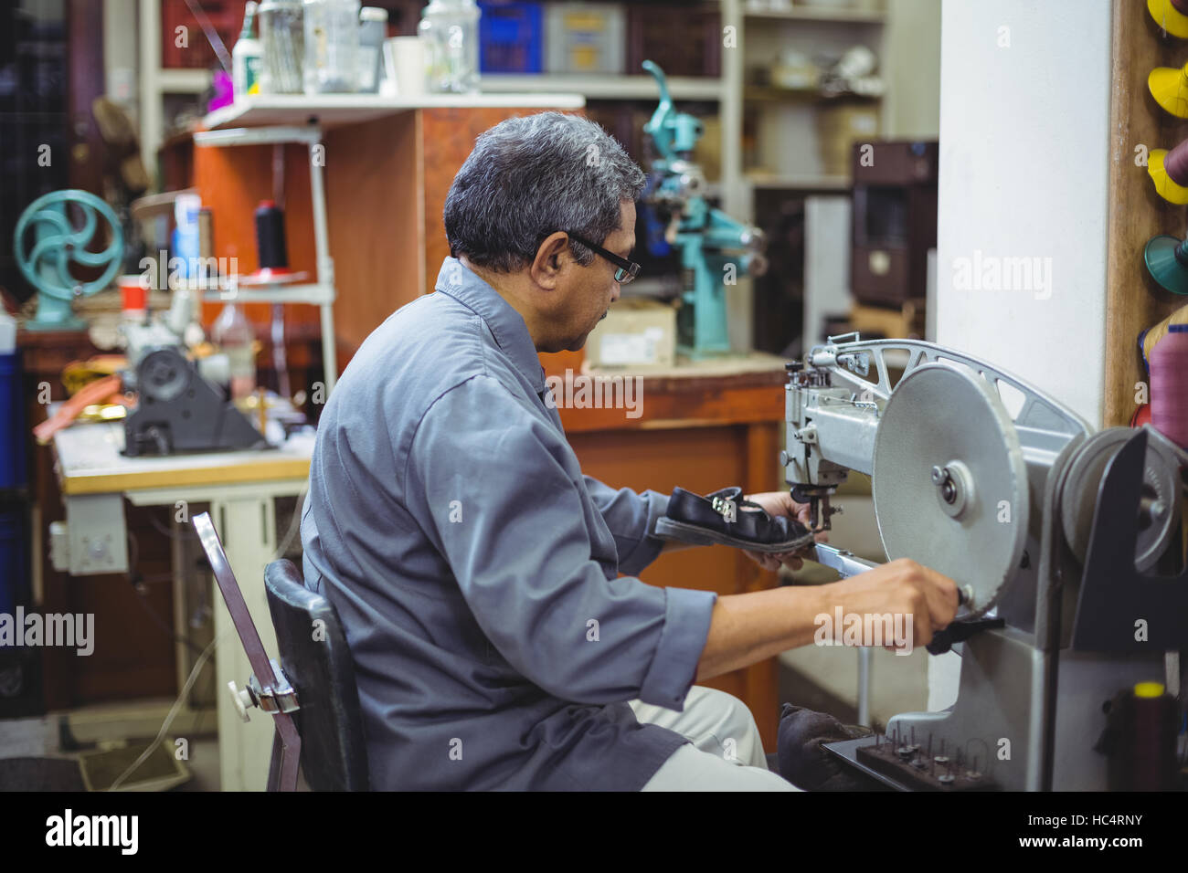 Shoemaker using sewing machine Stock Photo Alamy