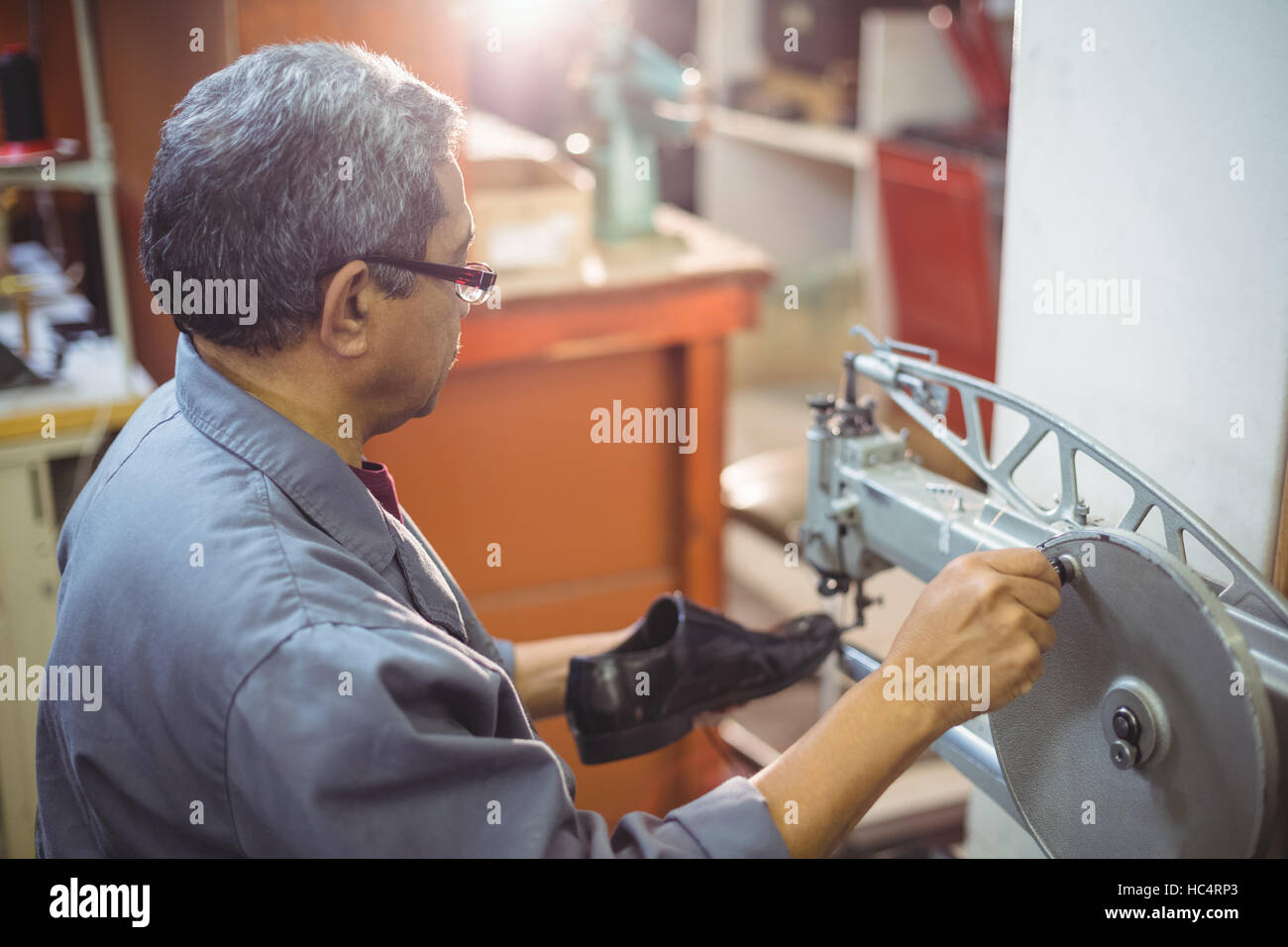 Shoemaker using sewing machine Stock Photo Alamy