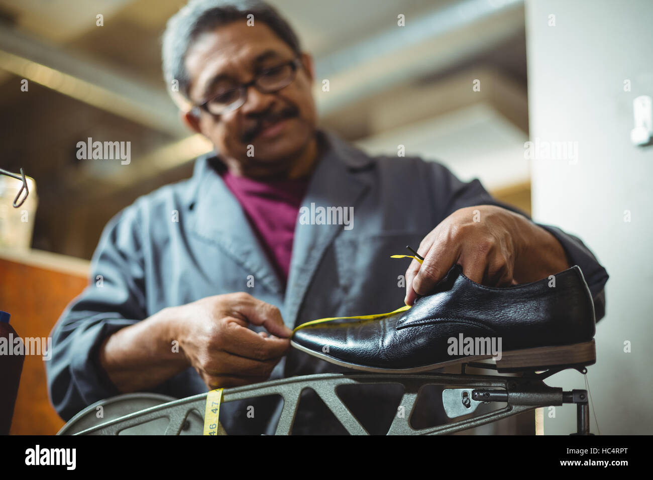 Shoemaker measuring a shoe with measure tape Stock Photo Alamy