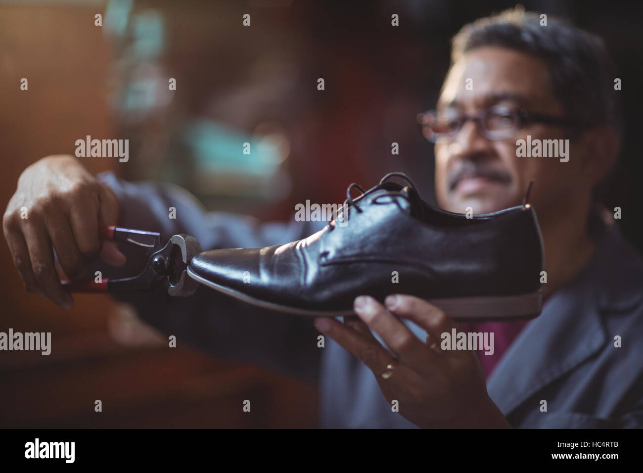 Shoemaker repairing a shoe Stock Photo Alamy
