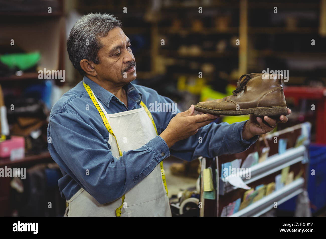 Shoemaker examining a shoe Stock Photo - Alamy