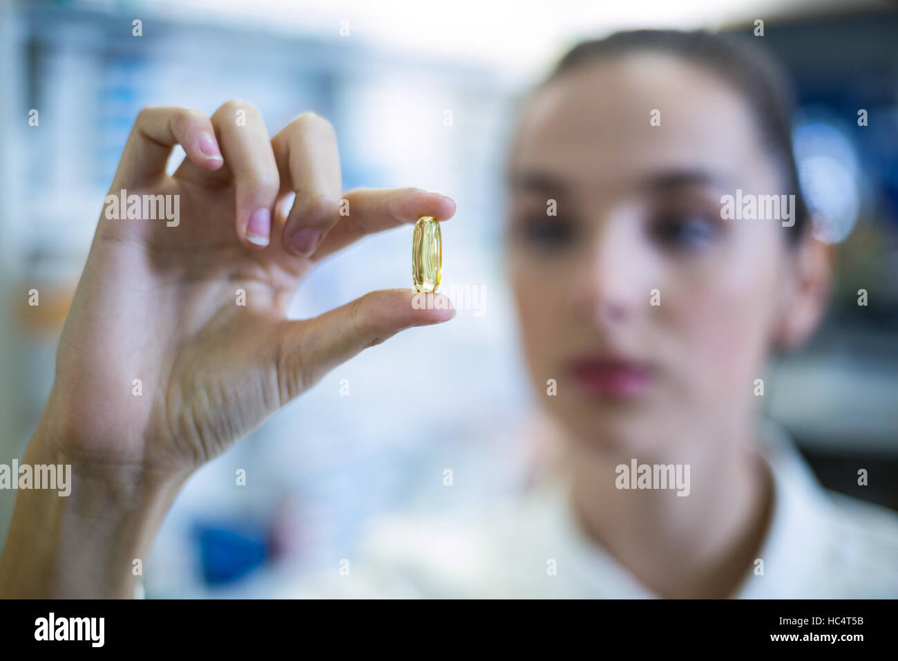 Pharmacist checking a capsule Stock Photo Alamy