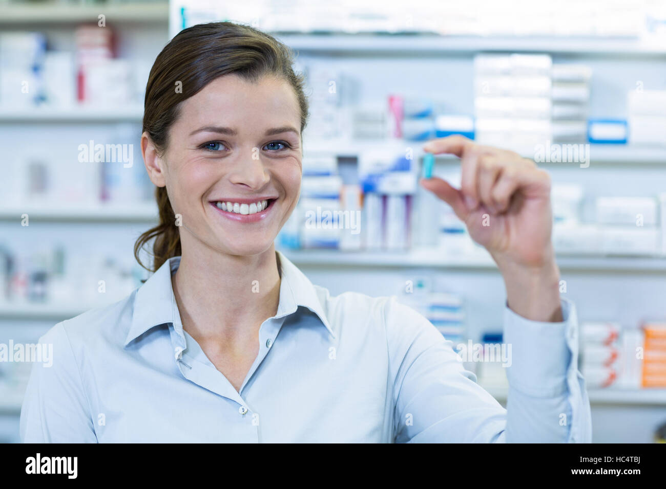 Pharmacist checking a capsule in pharmacy Stock Photo Alamy