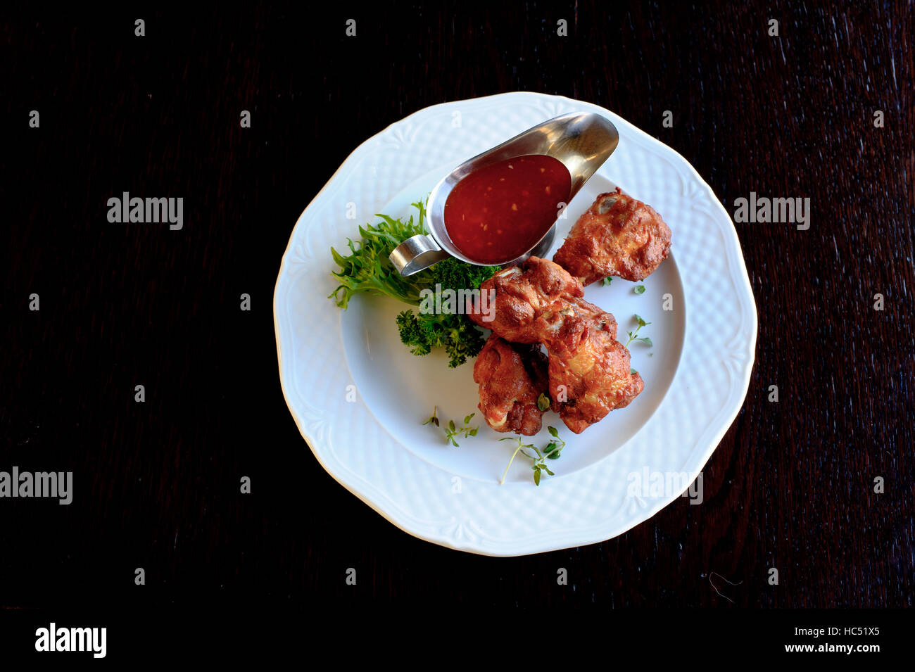 grilled chicken wings with spicy tomato sauce in white plate Stock Photo