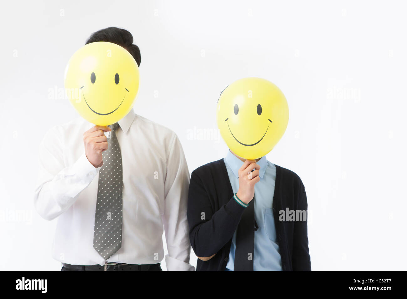 Father and son with balloons of smiling faces Stock Photo