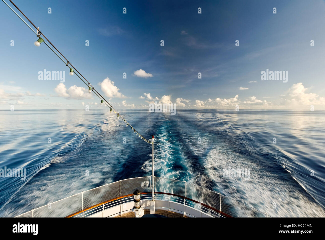 A cruise ship wake stretching from the stern to the horizon across a