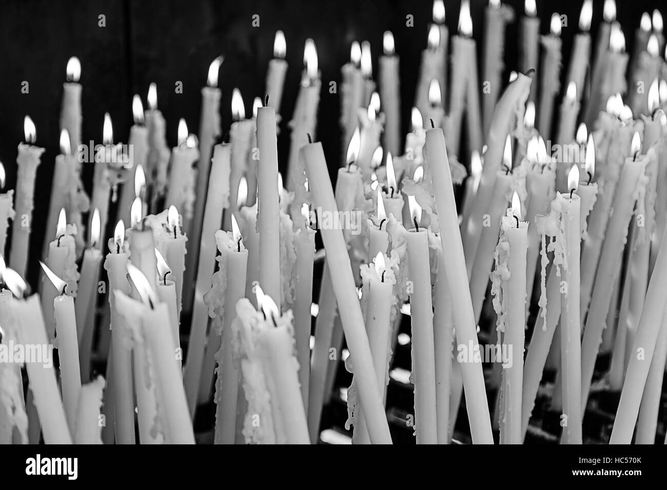 White lit candles in religious shrine, symbolism Stock Photo Alamy