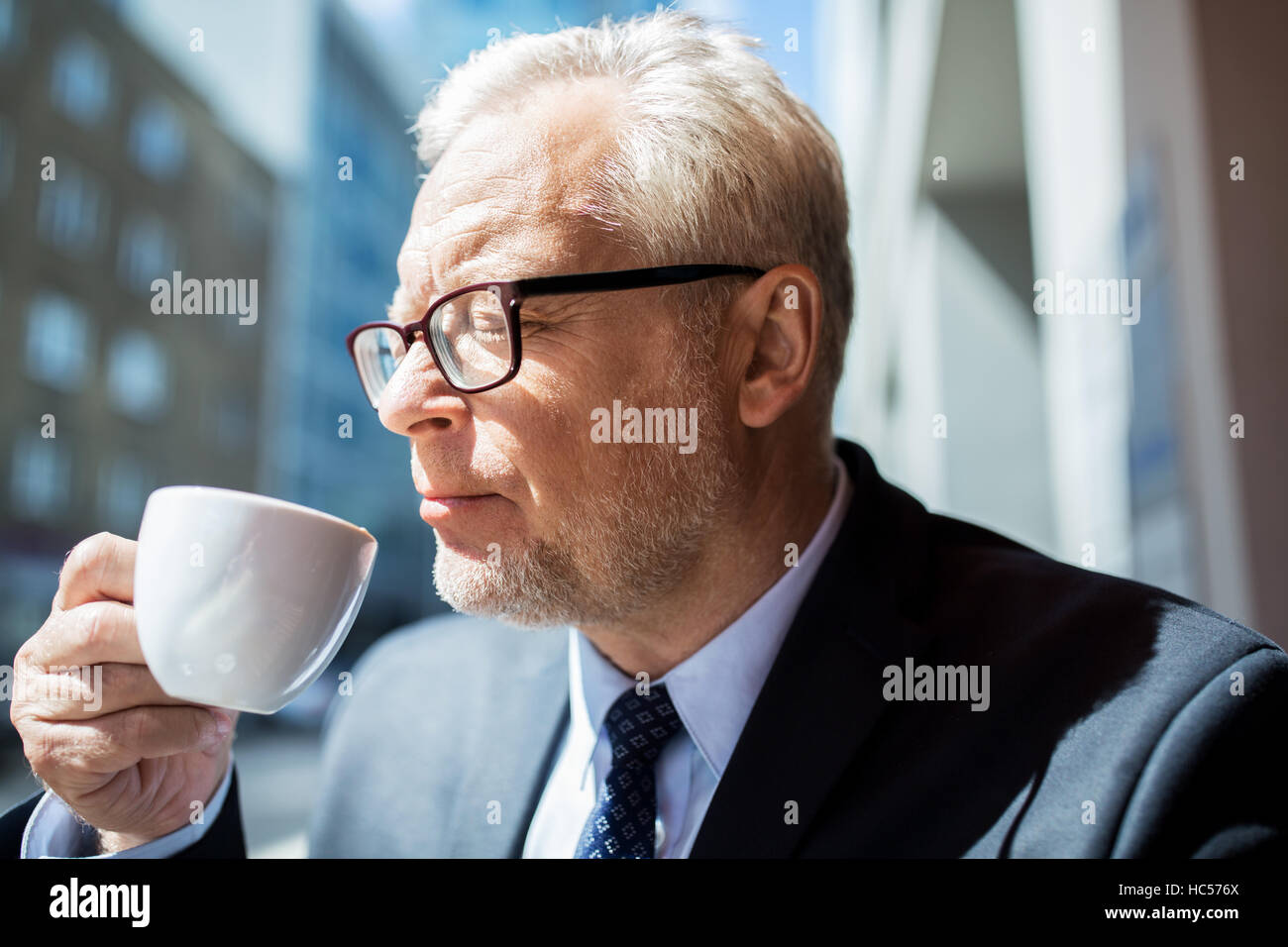 senior businessman drinking coffee on city street Stock Photo - Alamy