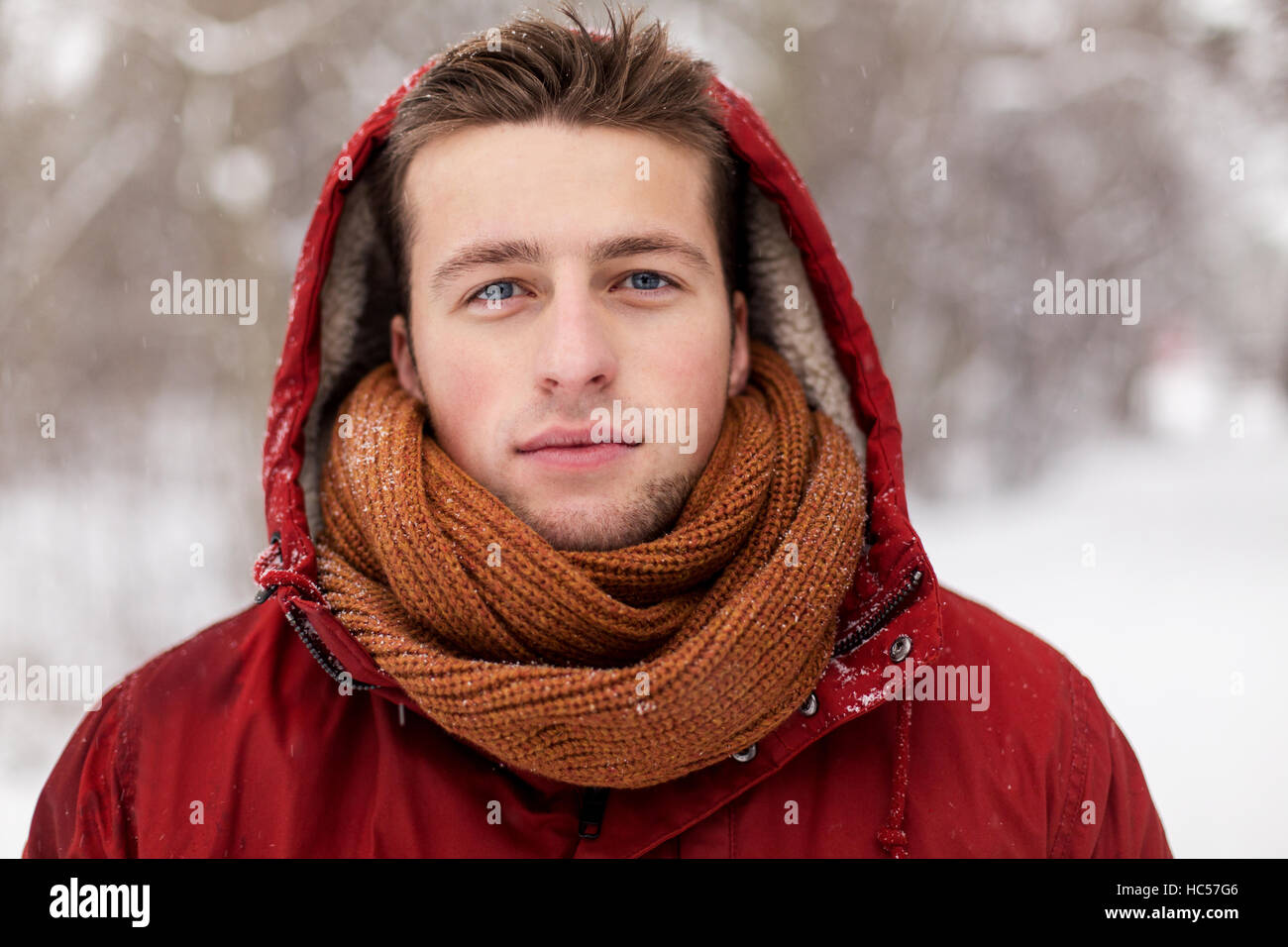 happy man in winter jacket with hood outdoors Stock Photo - Alamy