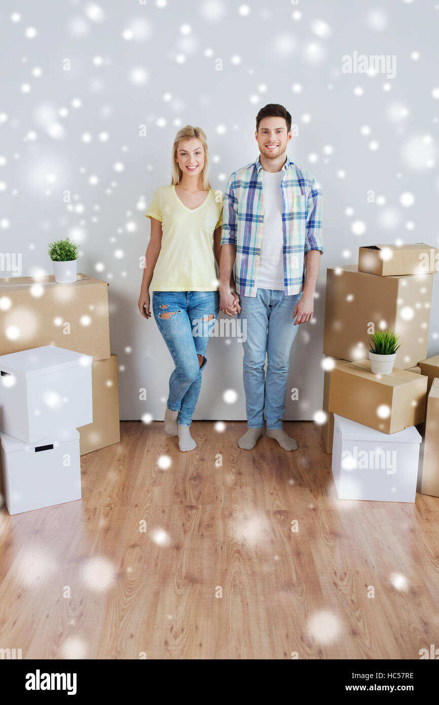 smiling couple with big boxes moving to new home Stock Photo - Alamy