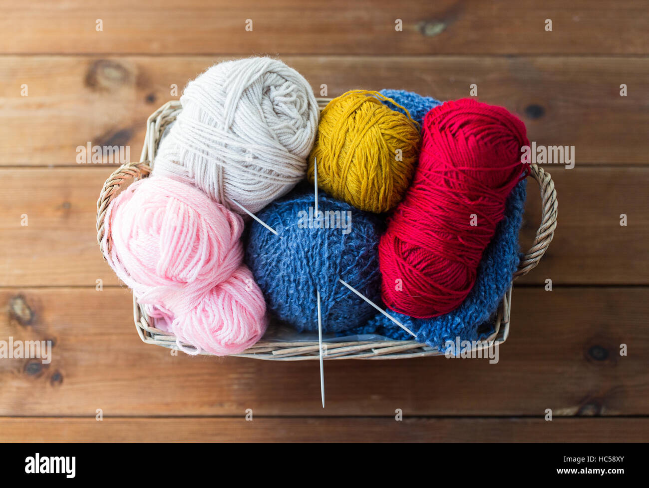 basket with knitting needles and balls of yarn Stock Photo - Alamy
