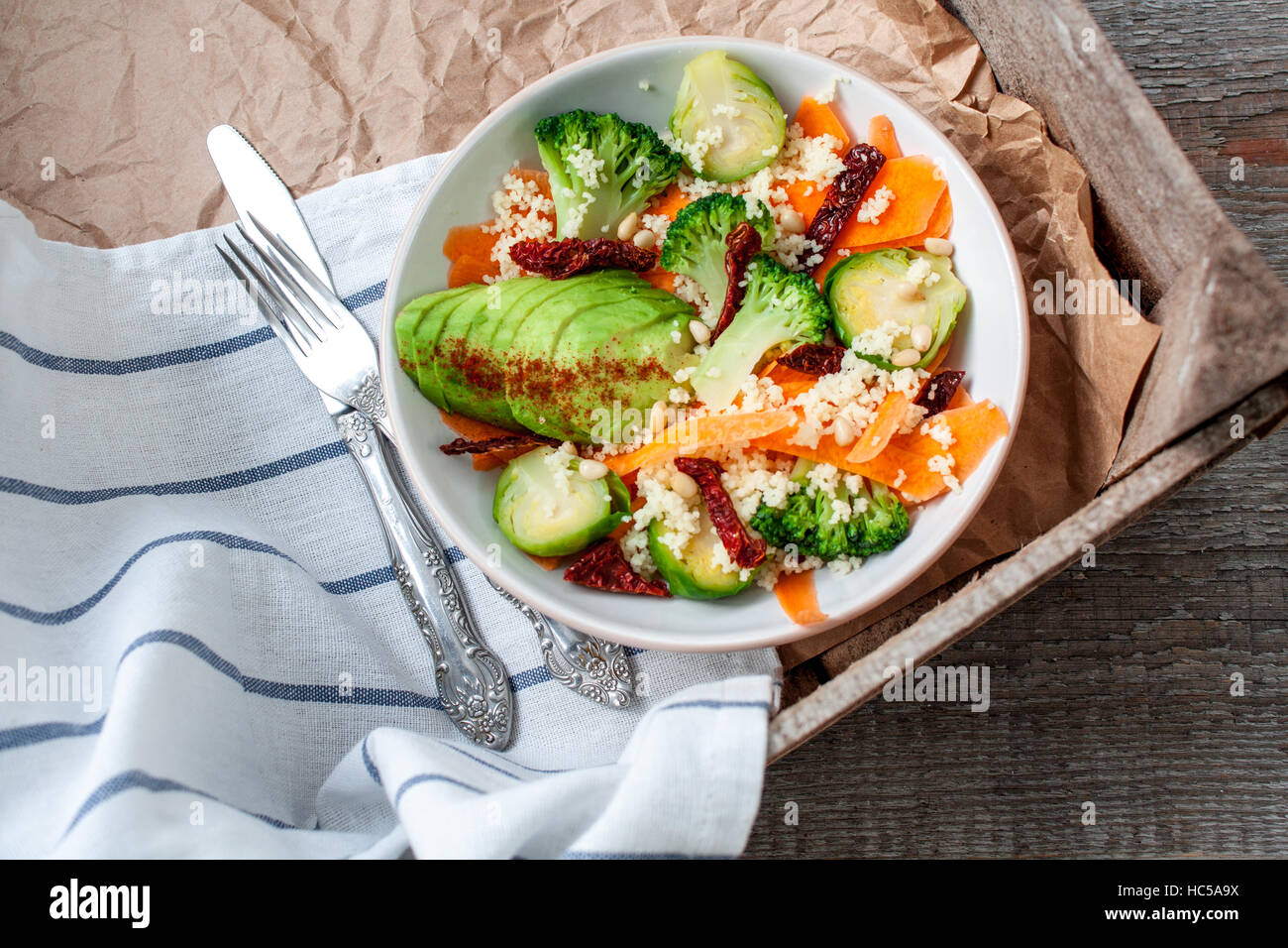 Couscous with broccoli, avocados, carrots, Brussels sprouts, dried