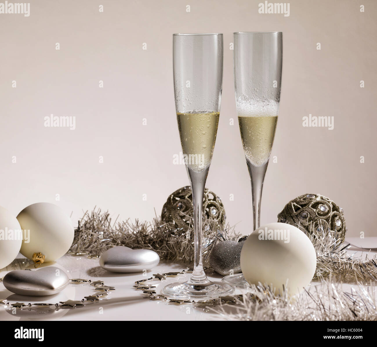 Pair of champagne glasses with silver ornaments and christmas balls