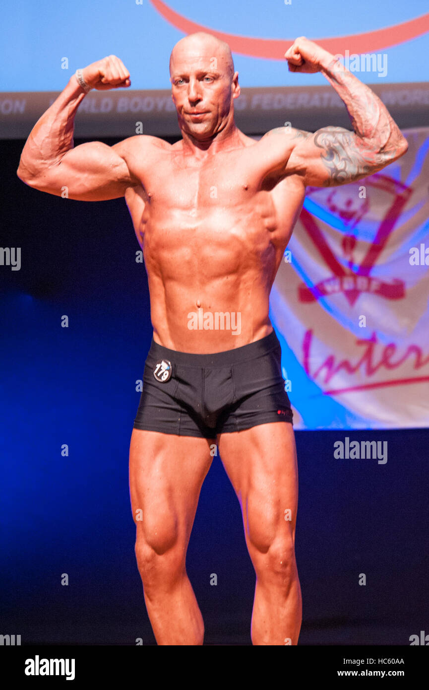 MAASTRICHT, THE NETHERLANDS - OCTOBER 25, 2015: Male bodybuilder Erik Stobbe shows his best front double biceps pose at the World Grandprix Stock Photo