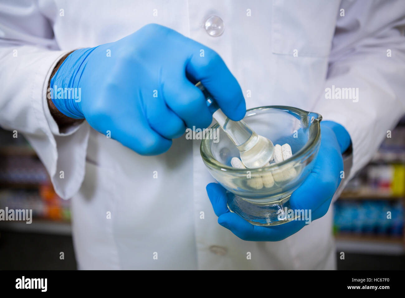 Pharmacist grinding medicine with mortar and pestle Stock Photo Alamy