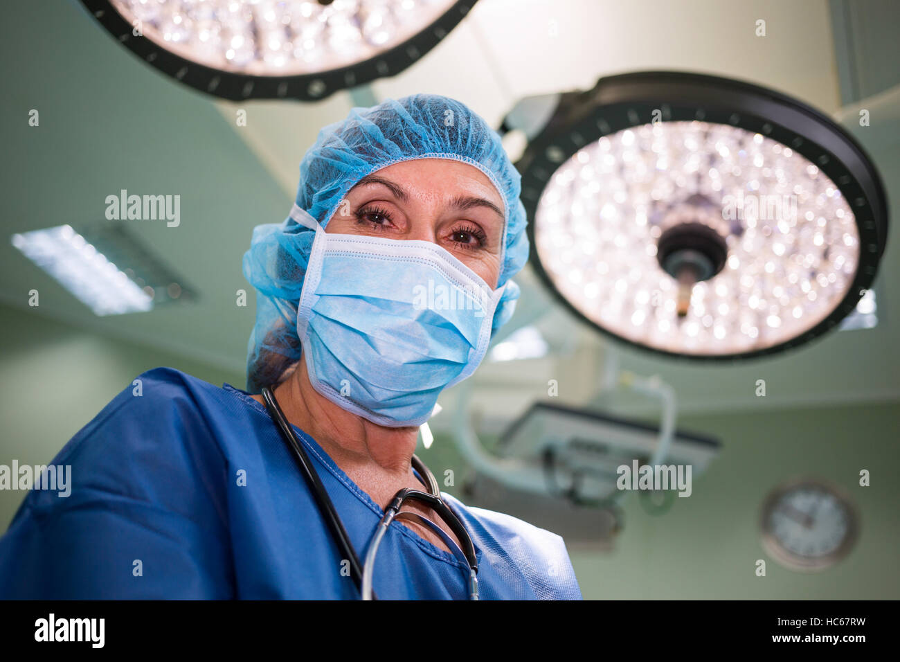 Portrait of surgeon standing in operation room Stock Photo - Alamy