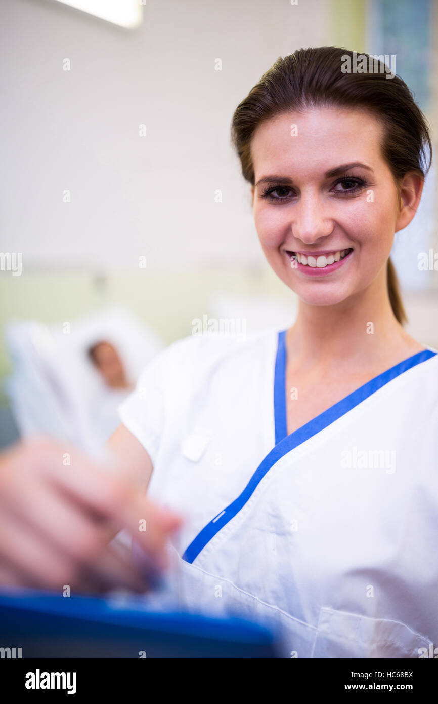 Close-up of female nurse holding clipboard Stock Photo - Alamy