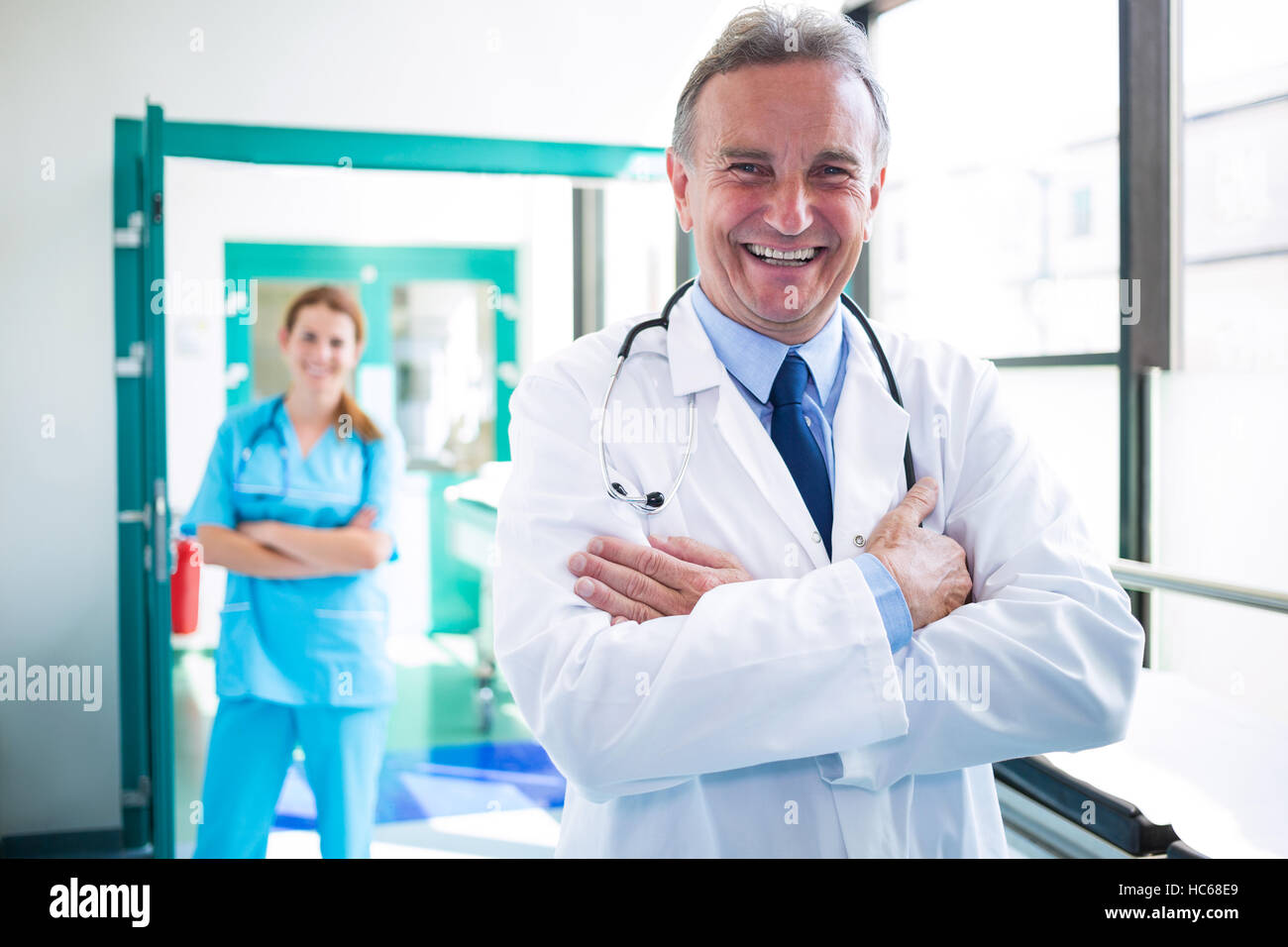 Portrait of doctor and nurse standing with arms crossed Stock Photo - Alamy