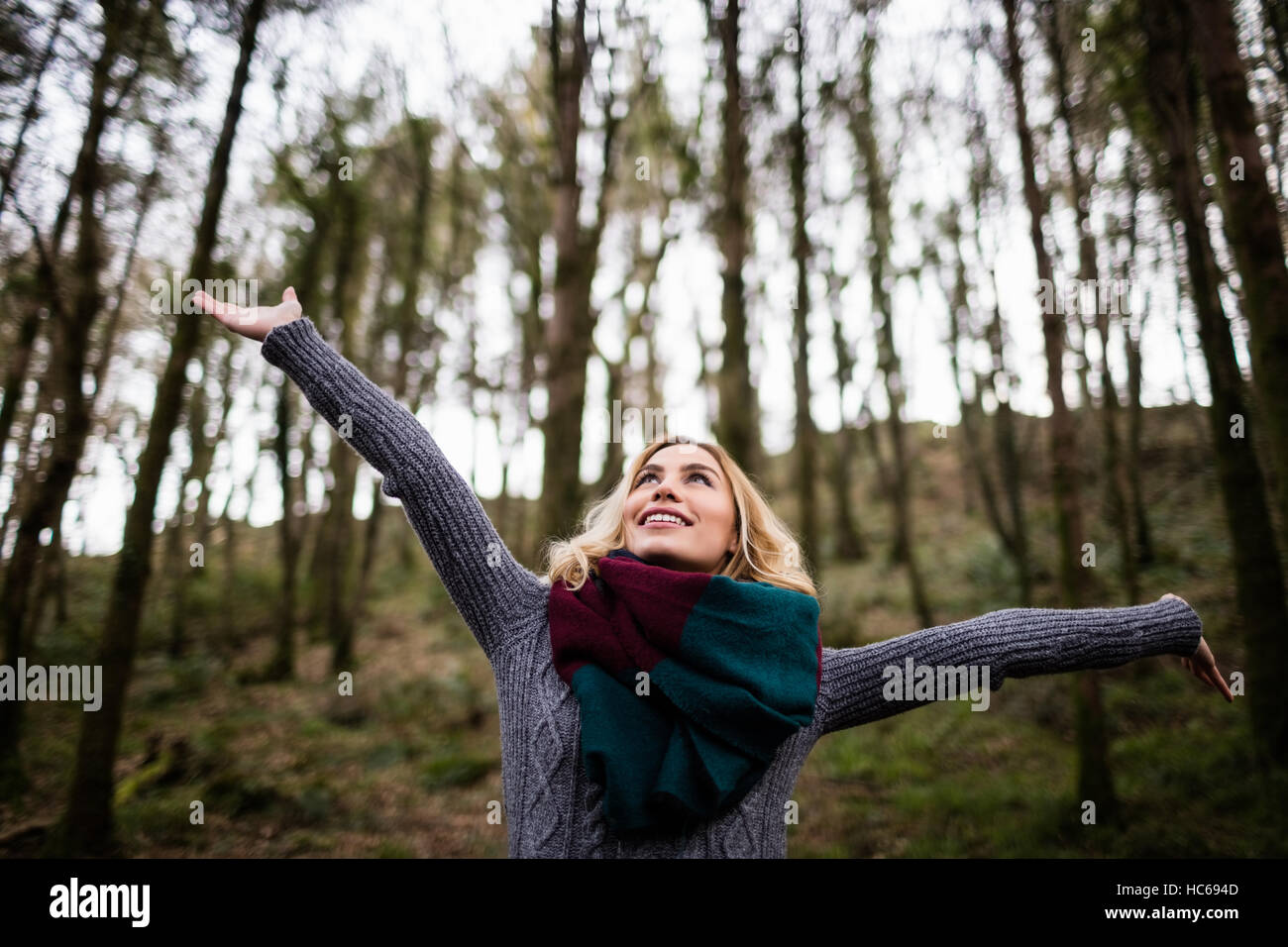 Beautiful woman standing with arms outstretched Stock Photo