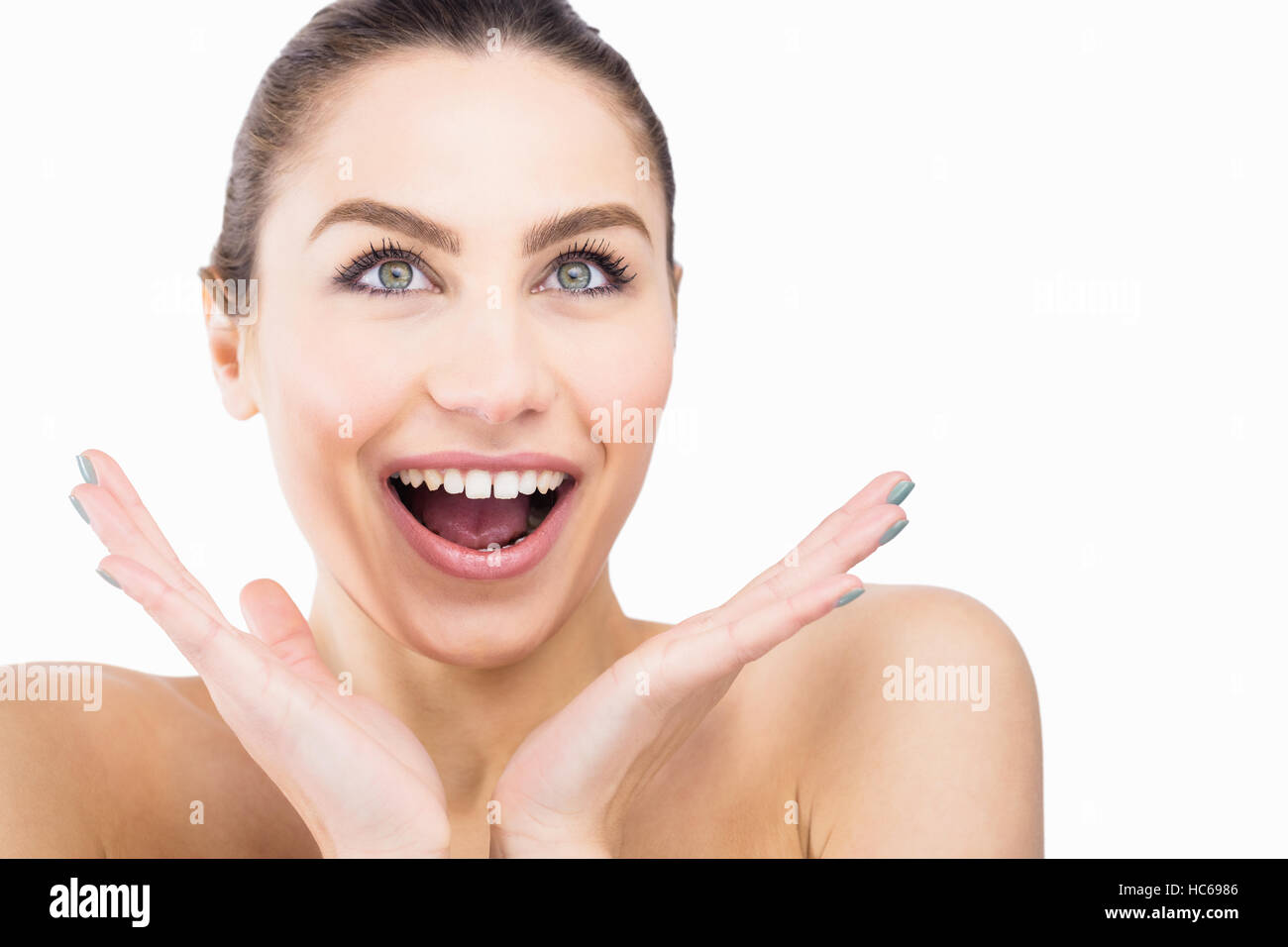 Beautiful woman posing with shocked expression against white background Stock Photo