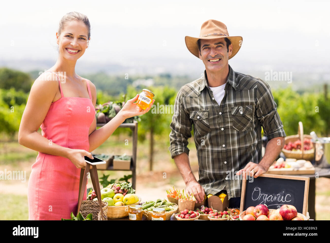 Portrait of farmer selling his organic produce to customer Stock Photo ...