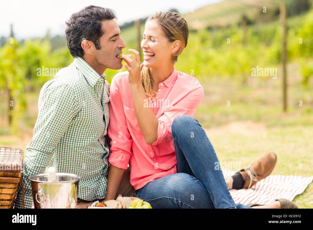 Woman feeding man with grape Stock Photo