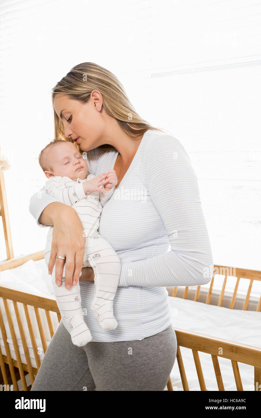 Mother holding and kissing her baby boy Stock Photo
