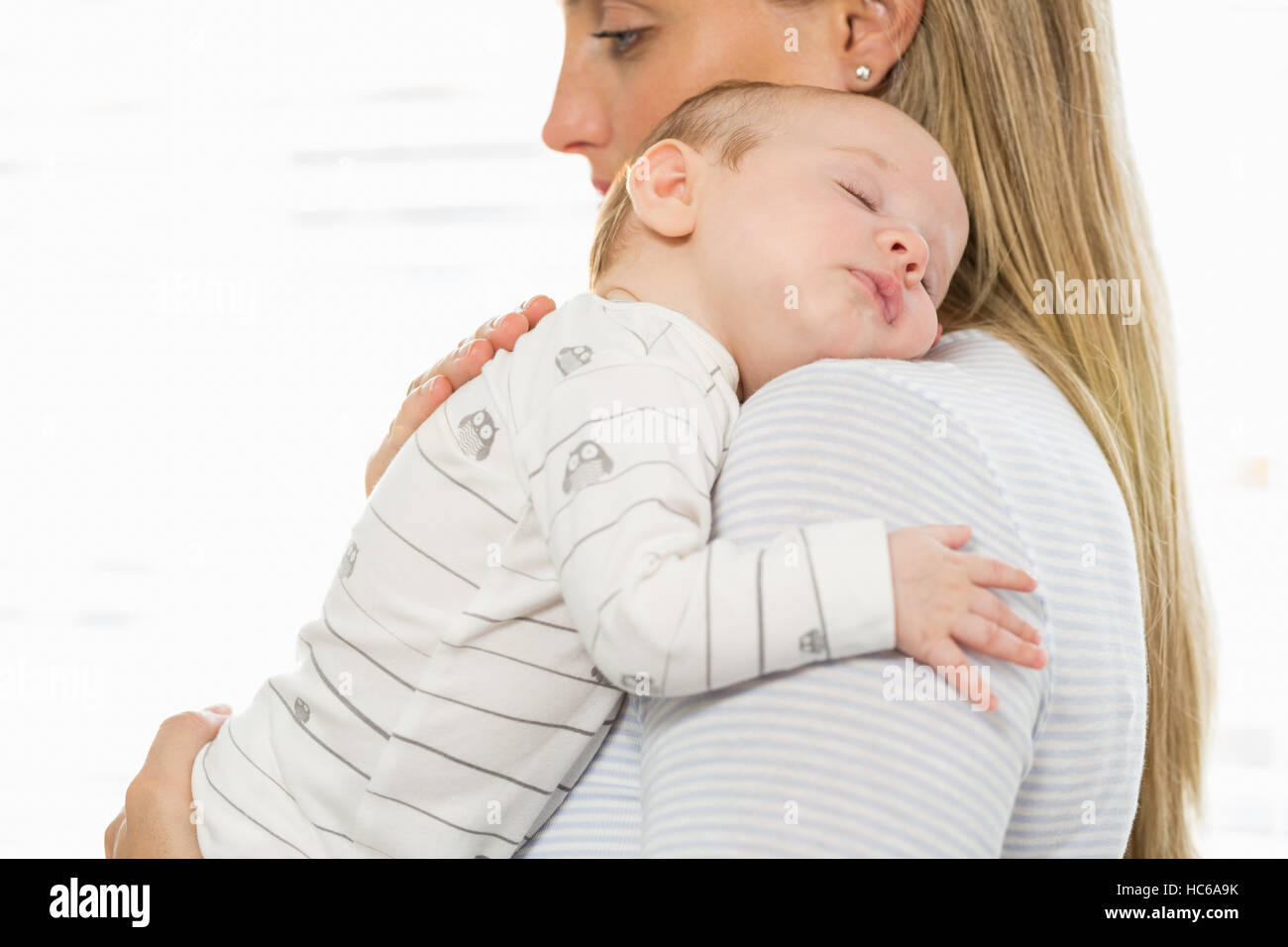 Mother holding and embracing her baby boy Stock Photo