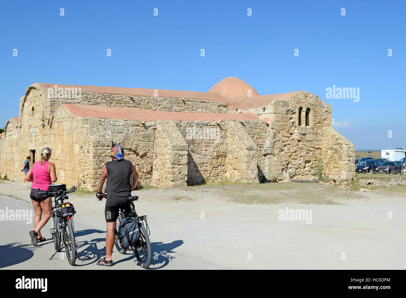 Cyclists, San Giovanni di Sinis church, Sinis, Cabras, Oristano District, Sardinia, Italy, Europe Stock Photo