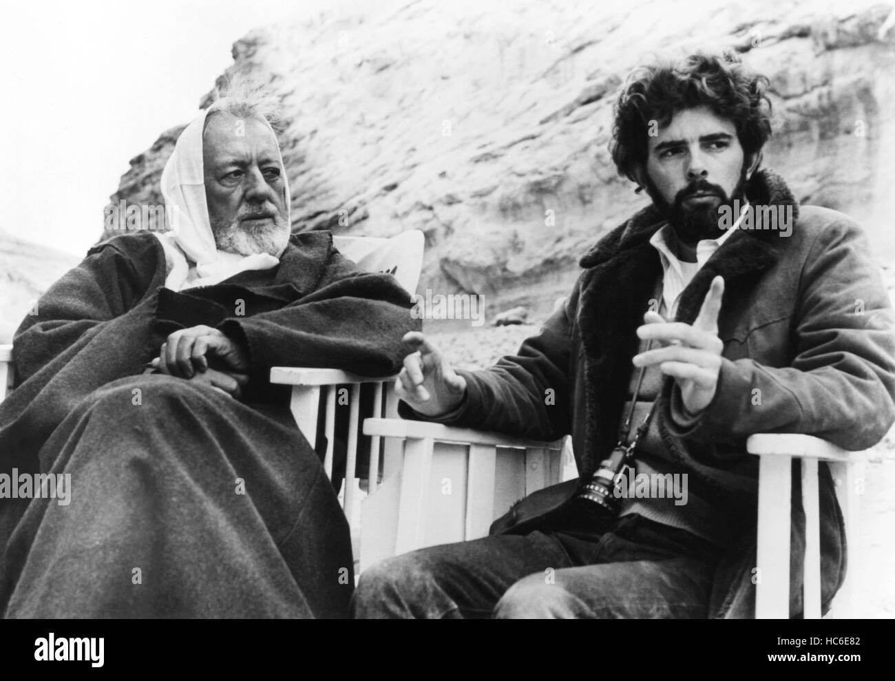 STAR WARS: EPISODE IV - A NEW HOPE, from left: Alec Guinness, director George Lucas on set, 1977, TM & Copyright © 20th Century Stock Photo