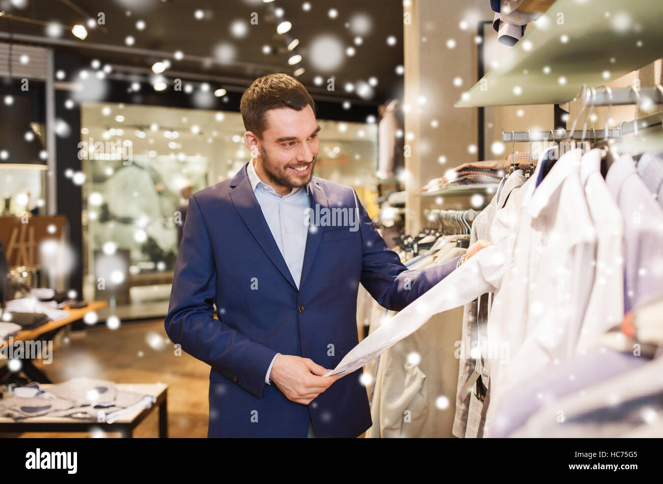 happy young man choosing clothes in clothing store Stock Photo - Alamy