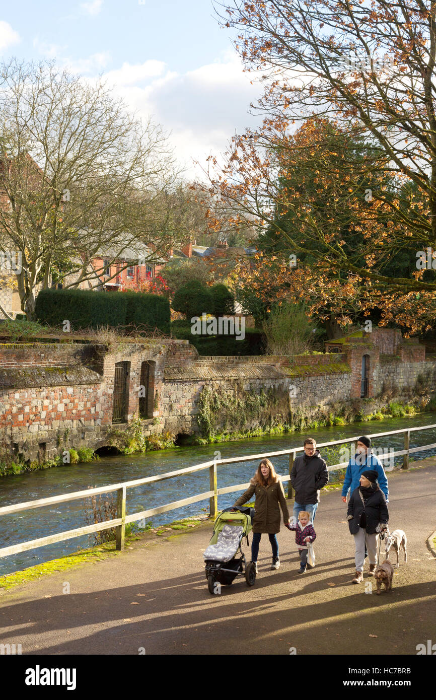 A family walking by the River Itchen in autumn, Winchester, Hampshire Stock Photo