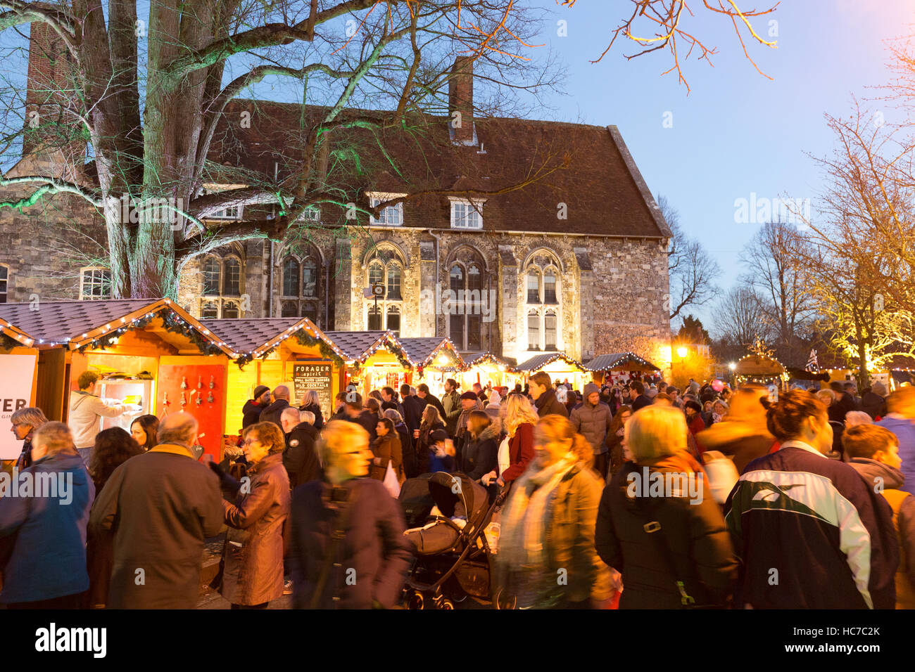 People shopping at stalls, Winchester Christmas market, Winchester, Hampshire UK Stock Photo