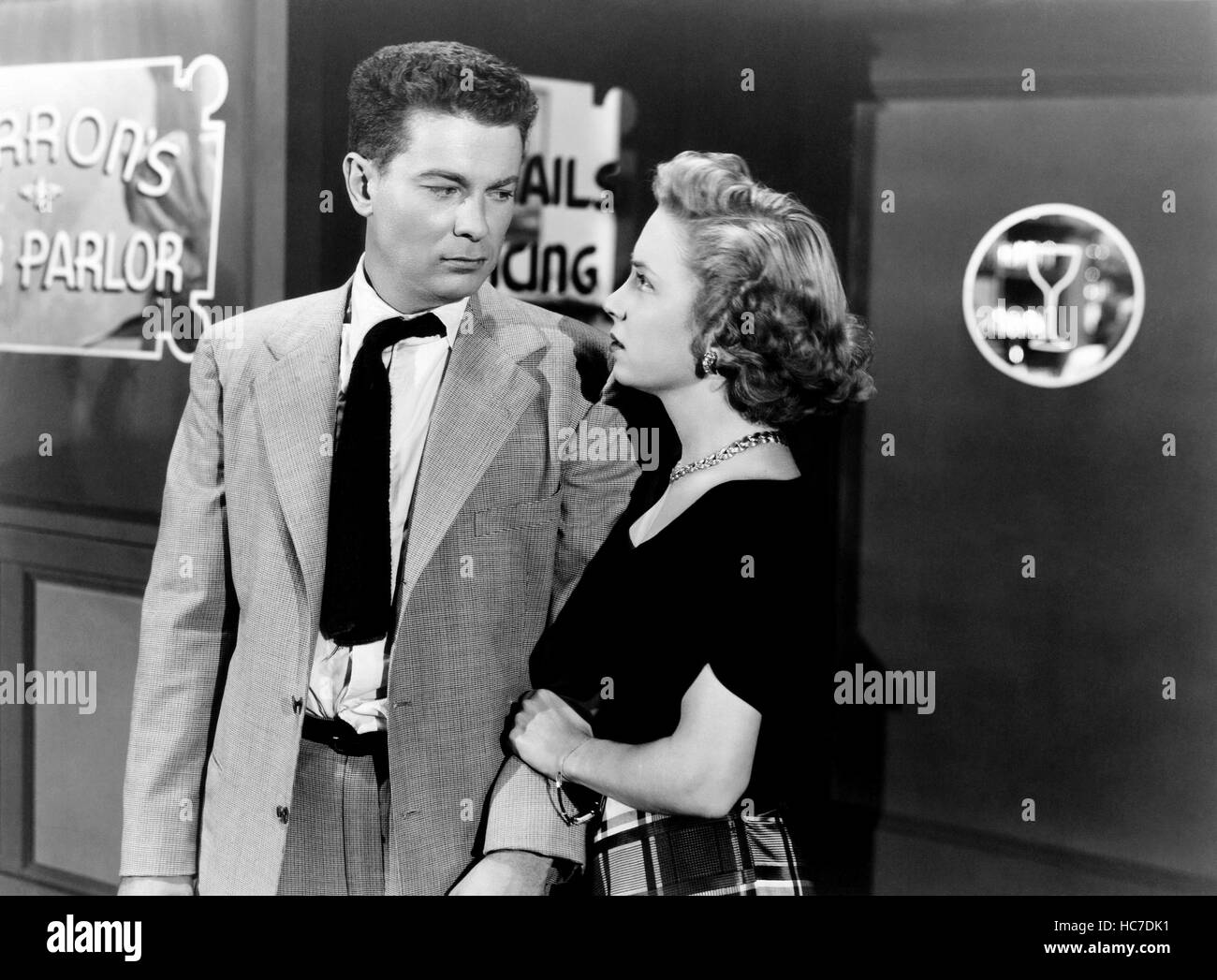 TARNISHED, from left, Arthur Franz, Dorothy Patrick, 1950 Stock Photo ...