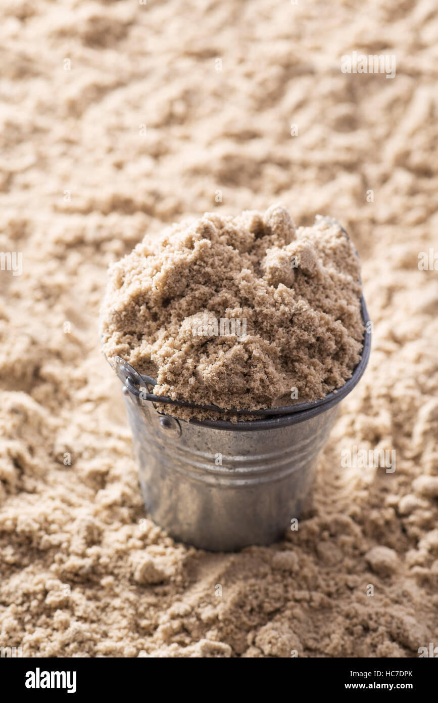 metal Bucket with sand at the beach Stock Photo