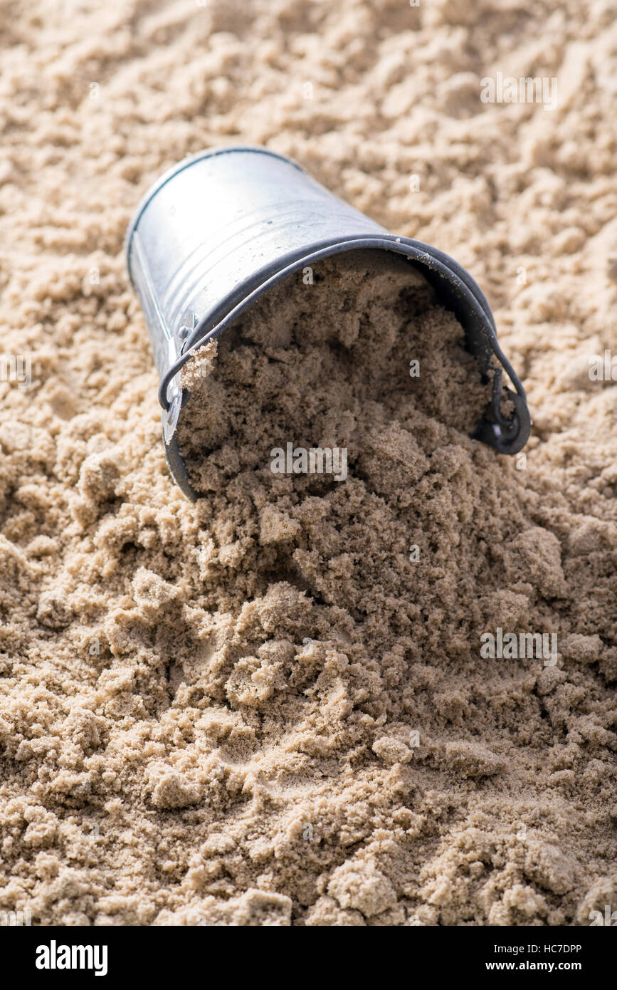 metal Bucket with sand at the beach Stock Photo