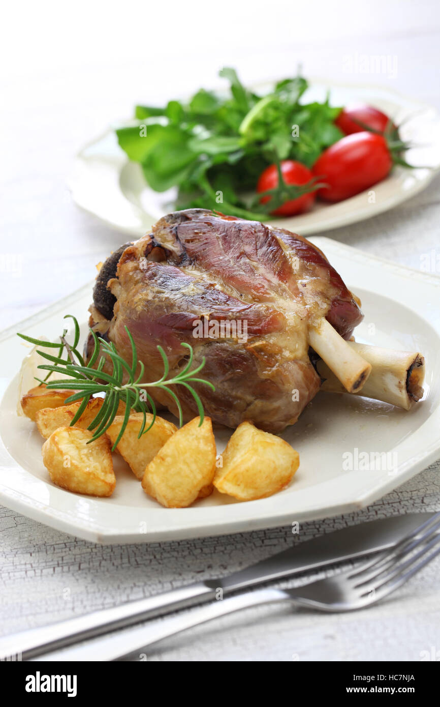 pork shank with roasted potatoes, italian cuisine, stinco di maiale con