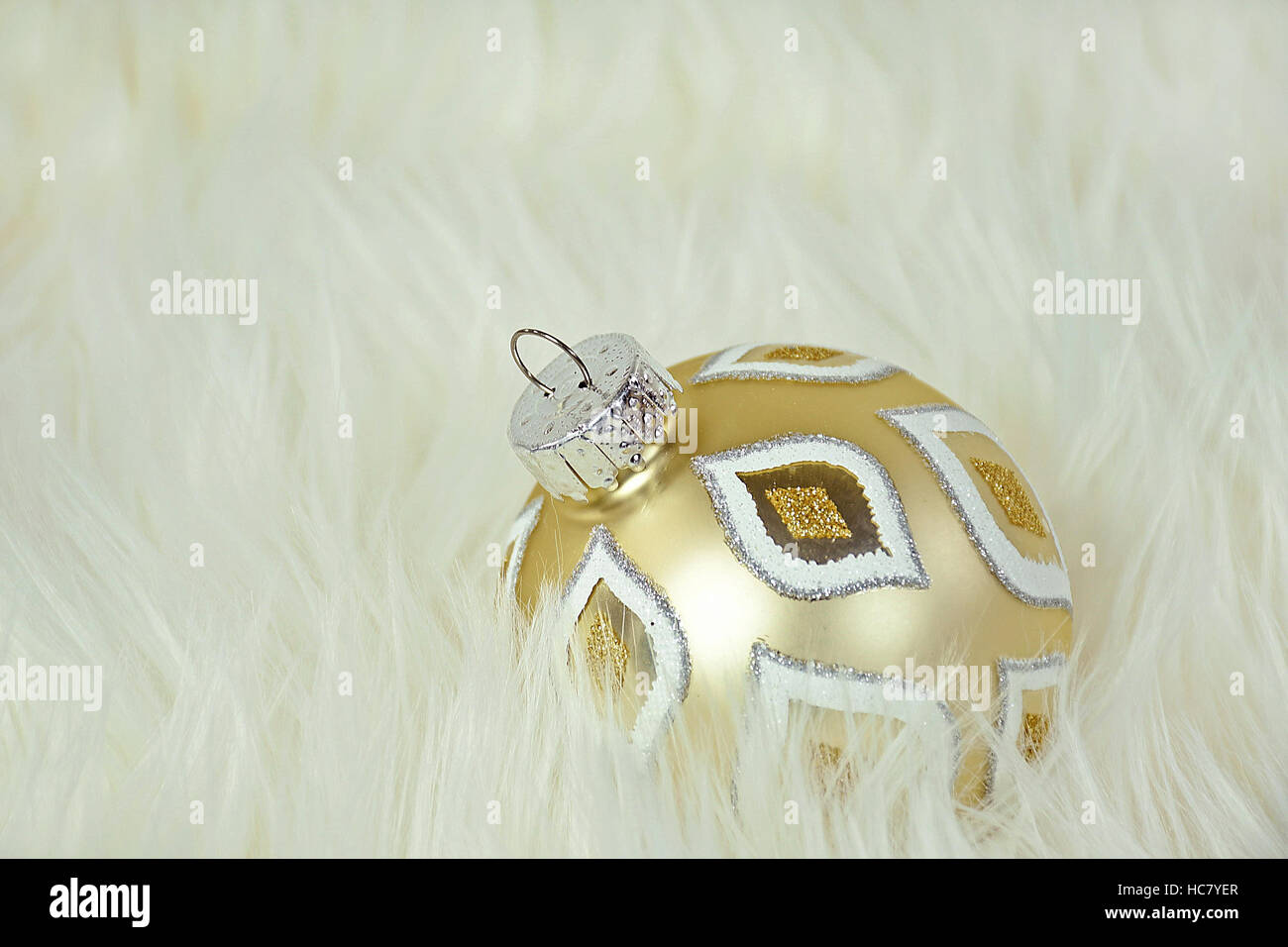 gold Christmas ornament in white fur Stock Photo Alamy