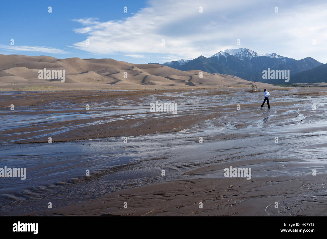 Saguache County, Colorado: Young girl fording Medano Creek at Great Sand Dunes National Park and Preserve. Stock Photo