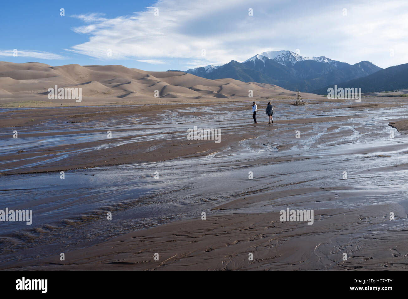Saguache County, Colorado: Young girls fording Medano Creek at Great Sand Dunes National Park and Preserve. Stock Photo