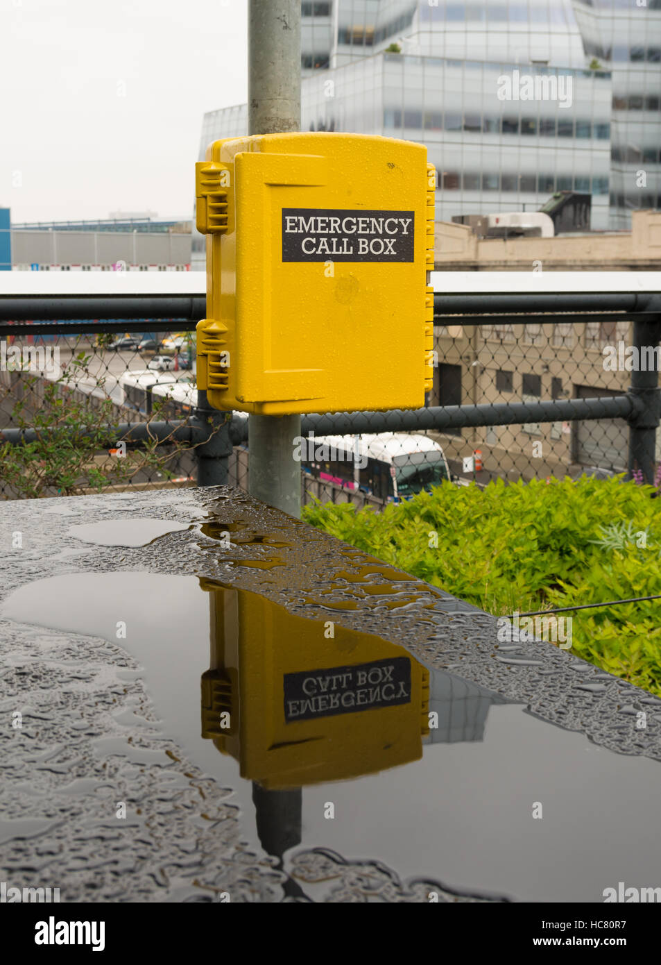 yellow emergency call box in New York for assistance in case of an emergency Stock Photo