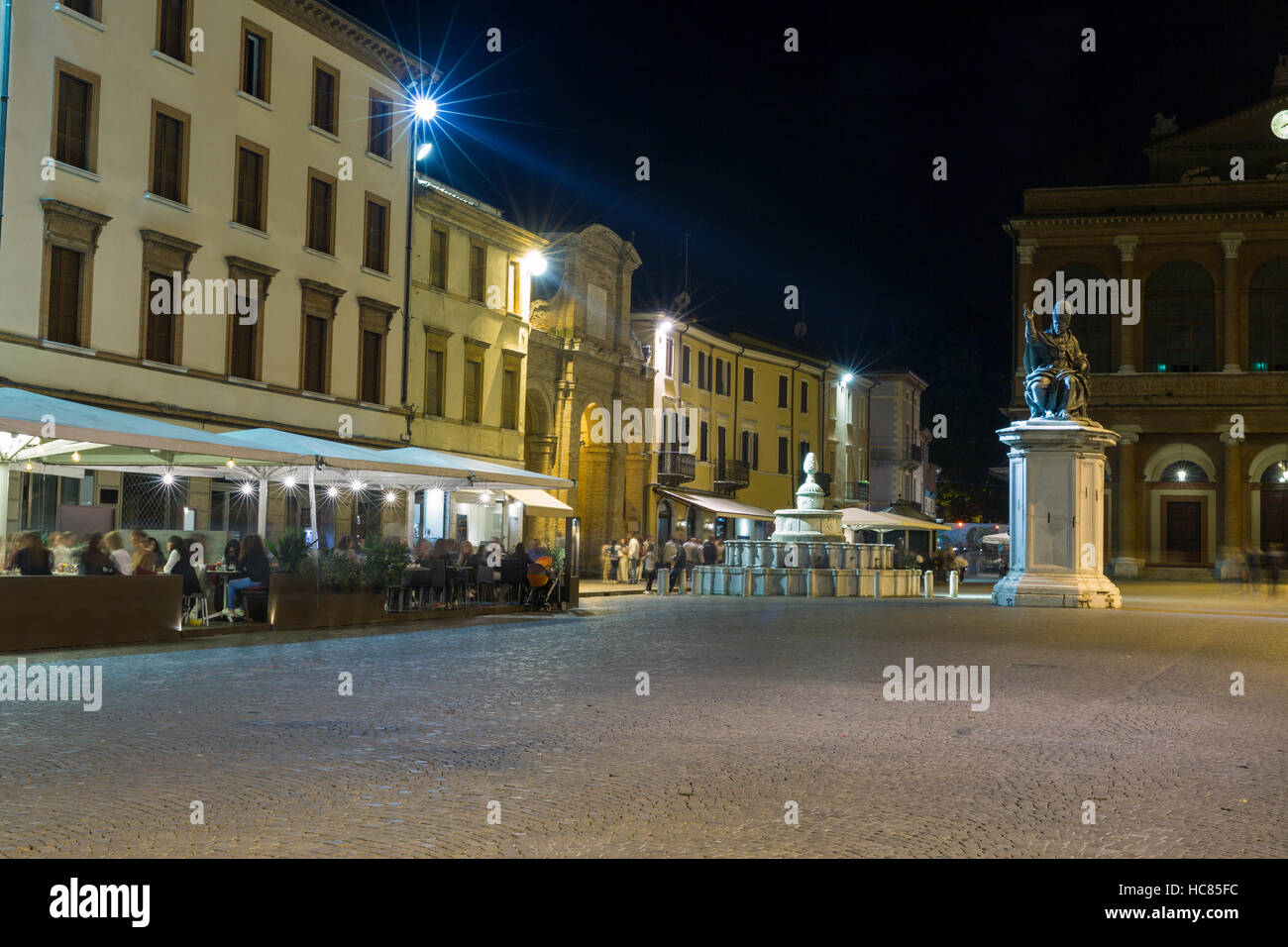 Cavour square with statue of Pope Paul V, Pigna fountain and public theater Amintore Galli at night in Rimini, Italy. Stock Photo