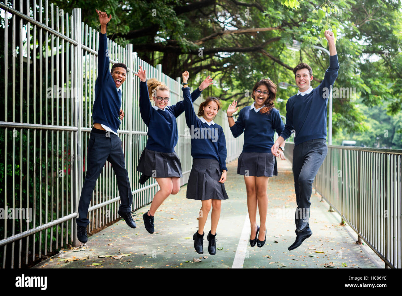 Jumping Enjoyment Friend Diverse Uniform Concept Stock Photo - Alamy