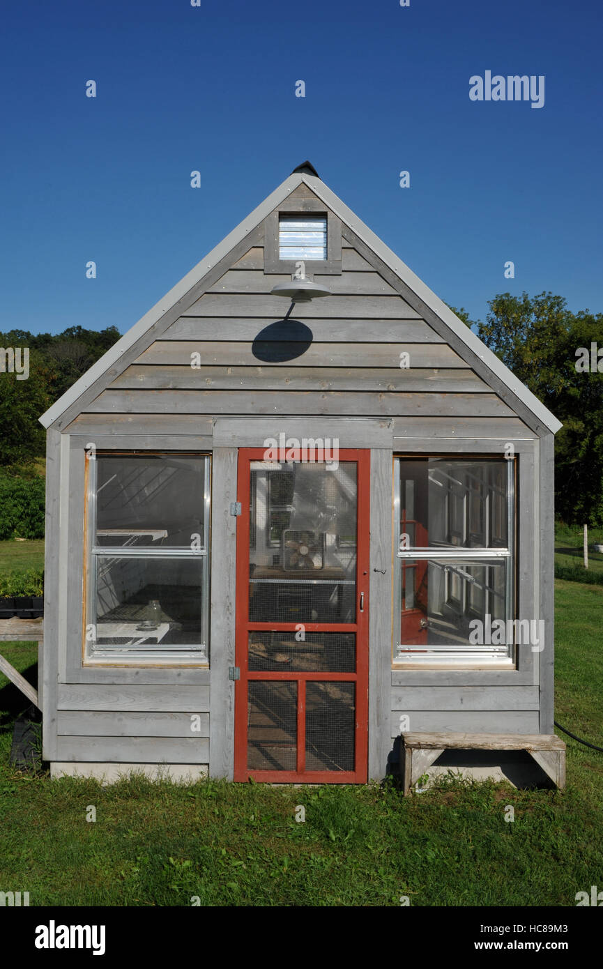 Greenhouse on clear sunny day with blue sky on Wisconsin farm outside