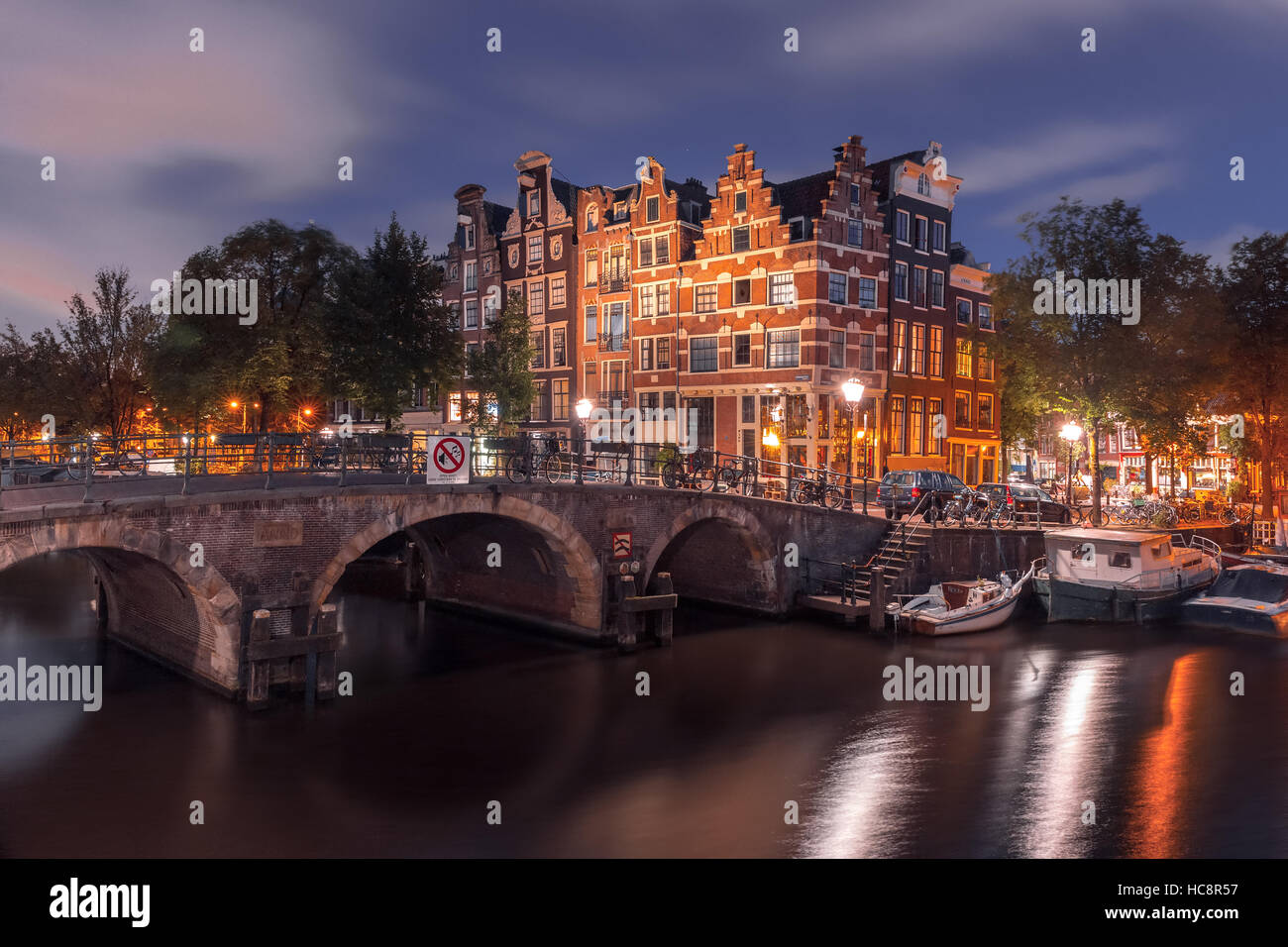 Night city view of Amsterdam canal and bridge Stock Photo