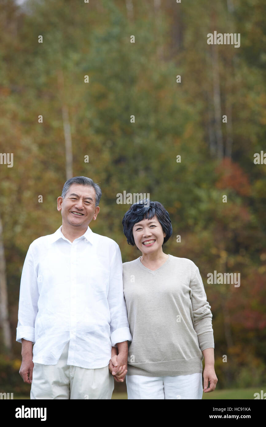 Asian couple holding hands taking hi-res stock photography and images ...