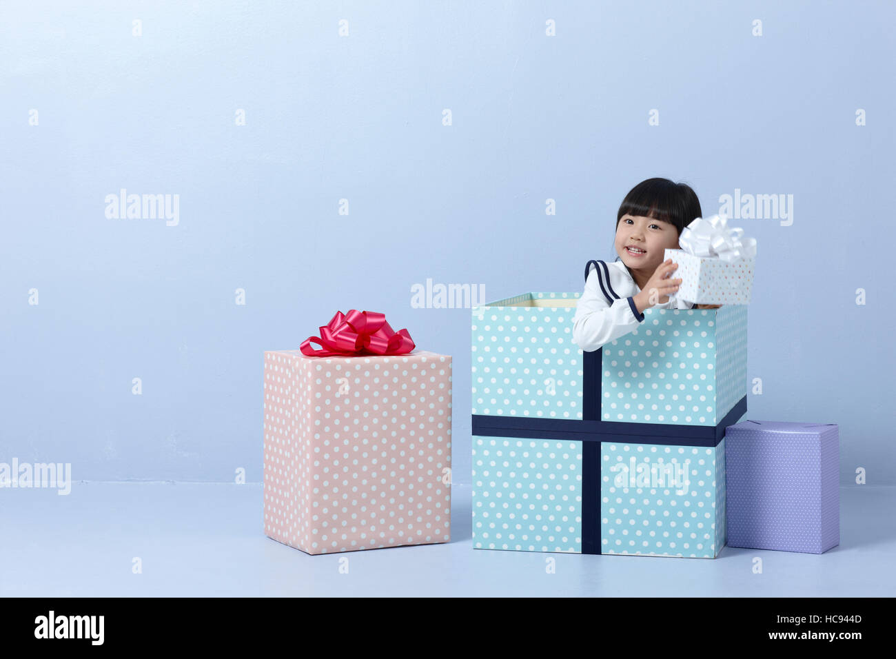Portrait of girl with present boxes Stock Photo - Alamy